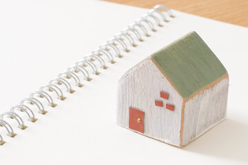 House building notebook and wooden house model