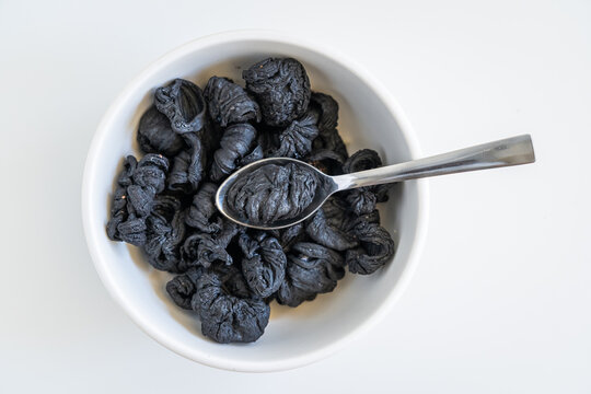 Dark sun-dried whole Malabar tamarind pods for use as a zesty cooking spice