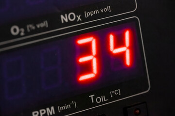 Automotive emissions testing equipment display showing measurement data with multiple parameter indicators visible