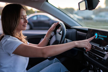 Young woman interacts with controls in autonomous driving vehicle
