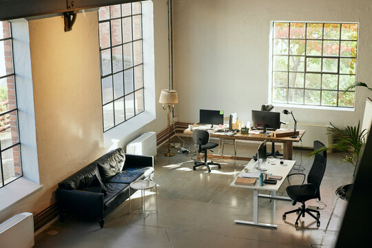 Overhead view of new tech office with desks and sofa