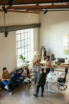 High angle view of business colleagues having meeting in startup office