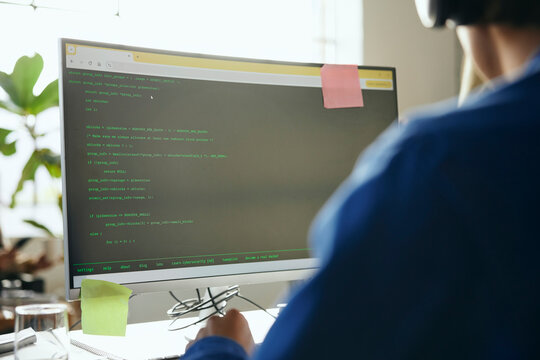 Coding language on desktop PC worked by male programmer in startup office