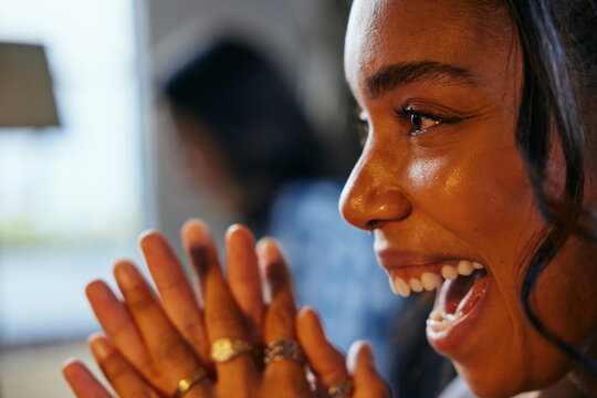 Headshot of happy businesswoman with mouth open in illuminated office