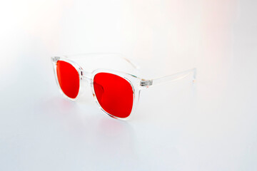 Transparent frame red lens eyewear designed to block blue light and support healthy circadian rhythms, presented in clean minimal composition.