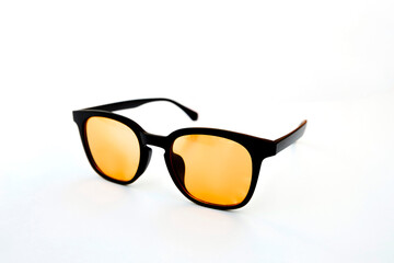 Modern black frame glasses with amber lenses to reduce eye strain and improve screen visibility during daytime work sessions.