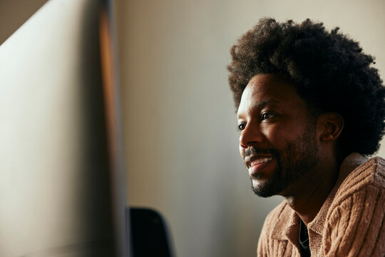 Businessman with curly hair working in tech startup office
