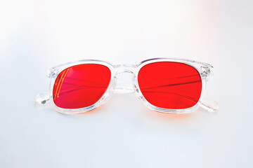 Frontal view of transparent frame red lens glasses designed for night use to reduce screen-related eye strain and support sleep.