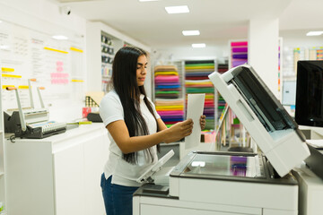 Woman making copies in cheerful print shop