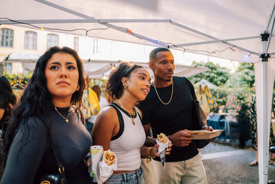 Woman spending leisure time with friends at street market