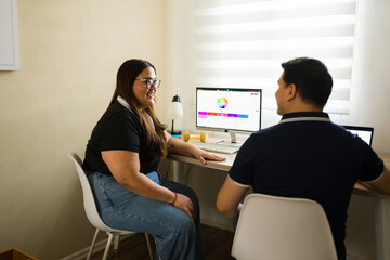 Graphic designers collaborating on a color palette for a new project in a modern office setup