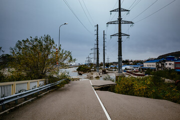 Damaged concrete bridge over mountain river. Consequences of flood