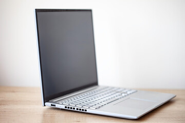 Close-up of gray laptop on a wooden table