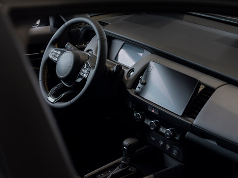 Modern vehicle interior featuring digital display steering wheel and automatic transmission in dark sophisticated design - Powered by Adobe