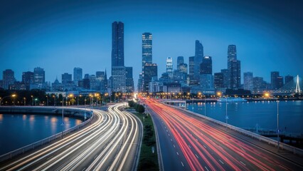 Obraz premium A dusk cityscape with streaking car lights on a bridge, reflecting the city lights