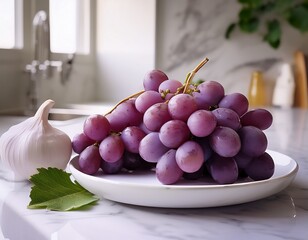 fresh purple grapexes on a white plate with a green leaf marble countertop soft light minimalist style garlic head in the background natural beauty