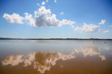 Limnos island alyki salt lake reflecting blue sky clouds