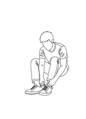 Obraz premium Young man sitting and tying shoelaces in casual clothing 