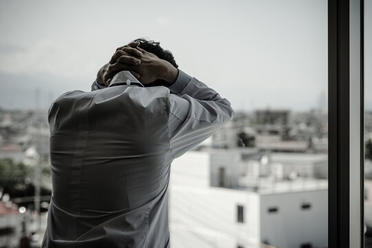 Male doctor holding his head (medical error, diagnostic error, surgical error, medical malpractice)