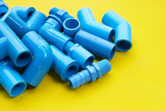 Assorted blue PVC connectors prepared for plumbing and piping work.