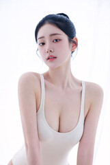 Naklejka premium Beautiful Young Asian Woman in Minimalist Swimsuit Posing against Bright White Studio Background for Beauty and Skincare Concept
