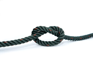 A single dark green twisted rope with red tracer highlights, tied into a simple overhand knot, positioned horizontally against a minimalist white background