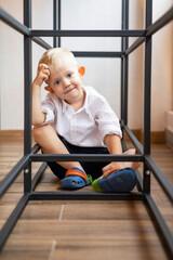 Portrait of a fashionable male child. Smiling boy posing, cubed. The concept of children's style and fashion.