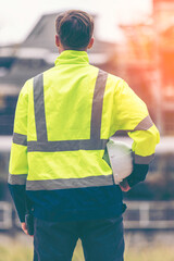  Engineers workers with tablet in a refinery - oil processing equipment and machinery, Industry zone gas petrochemical. Factory oil storage tank and pipeline. Workers in the refinery construction.