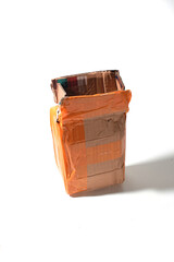 used cardboard packages with brown tape isolated on white background