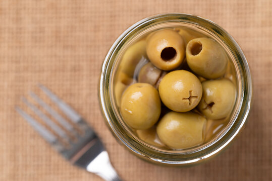 Pickled olives, Pitted green olives in glass jar, Top view