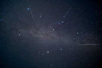 A stunning long exposure of Geminid meteor shower streaks across the Winter Hexagon asterism and a...