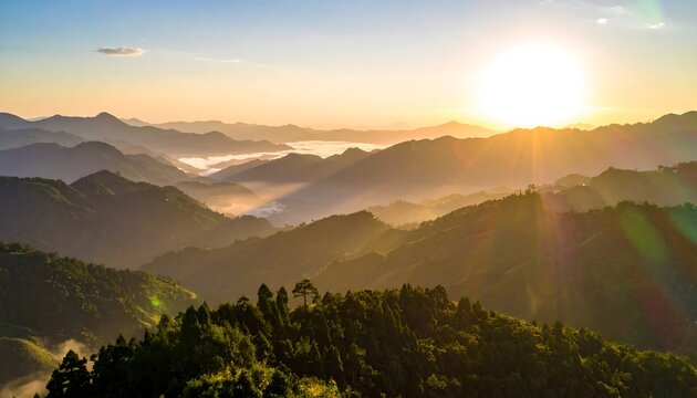 A scenic sunrise bathes mountain ridges in golden light, casting shadows and revealing misty valleys in the distance