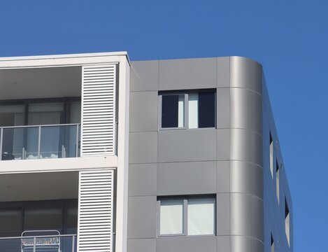 Modern apartment building with curved cladding and balconies