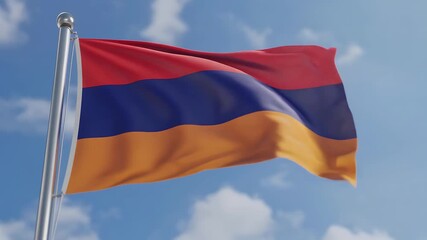 Armenian flag waving in the wind against a blue sky