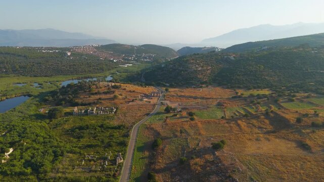 Gelemis, Turkey. Ancient city gate with modern road and Hurmalik Hamami thermal baths at Tepecik, Patara archaeological site in summer morning. Aerial View