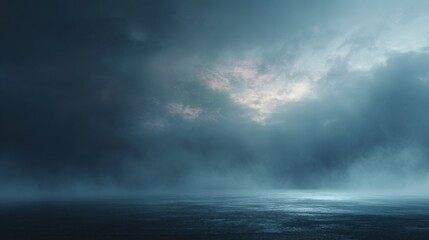 Obraz premium A moody seascape featuring dark clouds and a calm ocean, illuminated by faint light from above, creating a serene yet dramatic atmosphere.