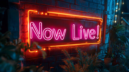 Neon sign with "Now Live!" glowing at night,Vibrant Neon Sign Displaying "Now Live!" Against a Brick Wall and Green Plants