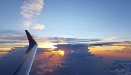 Obraz premium Breathtaking aerial perspective of an airplane wing soaring above a magnificent cloudscape during a vibrant sunset, illuminating the horizon with warm, golden hues