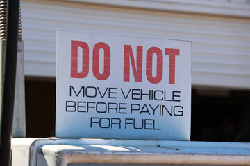 Do Not Move Vehicle Before Paying For Fuel sign at a petrol gas station