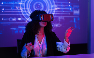 Woman engages with virtual reality technology in a futuristic setting during an evening session