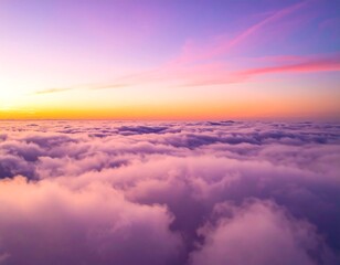 Aerial view of fluffy, cloud-filled expanse bathed in pastel colors