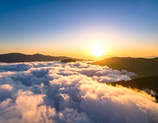 Aerial view of sunrise, clouds covering mountains, golden light