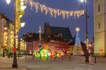 Festive Christmas light decorations on streets in Warsaw, Poland during night in winter