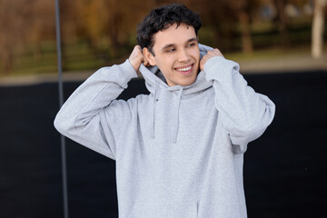 Young man in grey hoodie outdoors