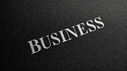 Fototapeta premium Closeup of embossed business text on dark textured surface.