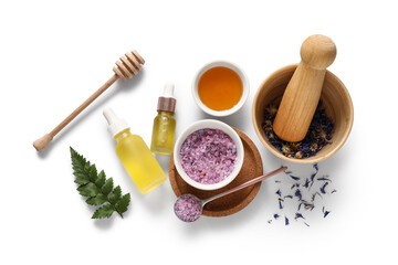 Fototapeta premium Mortar with pestle and ingredients for natural cosmetics on white background