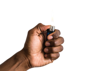 A close-up shows a dark-skinned hand holding a lighter, with a flame burning against a stark black background