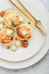 cottage cheese pancakes, syrniki, curd fritters with pear balls, walnut and honey