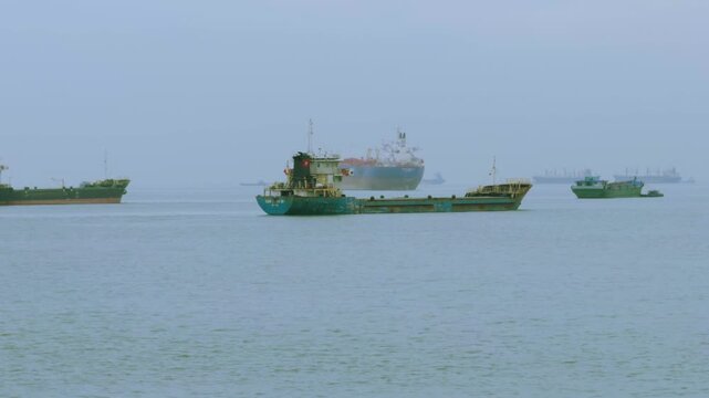 Cargo Barges and Container Ships Transiting Vung Tau River Mouth