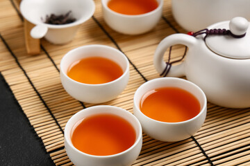 Cups with brewed Asian tea on table